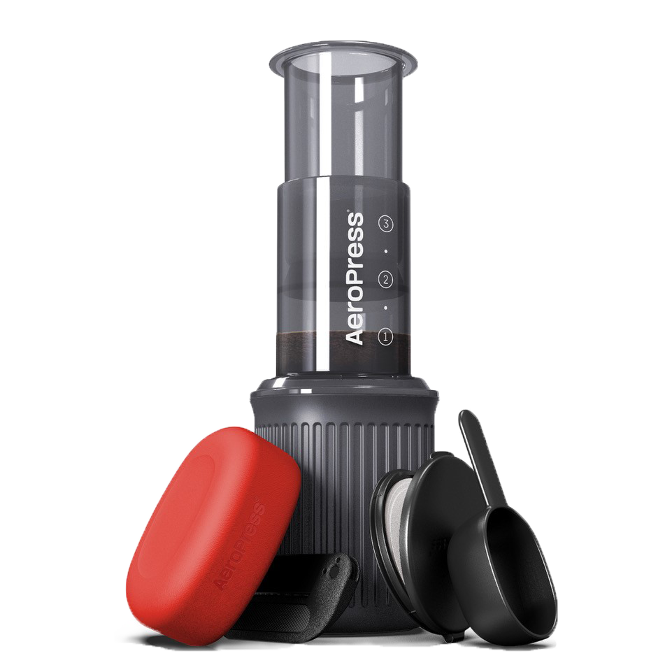  AeroPress Go coffee maker with red lid and black scoop on a white background 