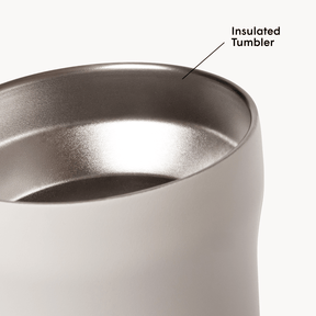Black insulated tumbler with metallic interior on a white background #color_cream