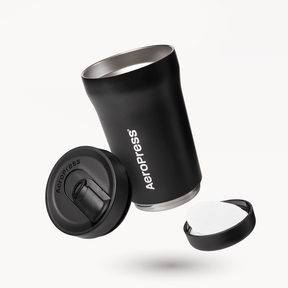 Black AeroPress tumbler with components on a white background #color_black