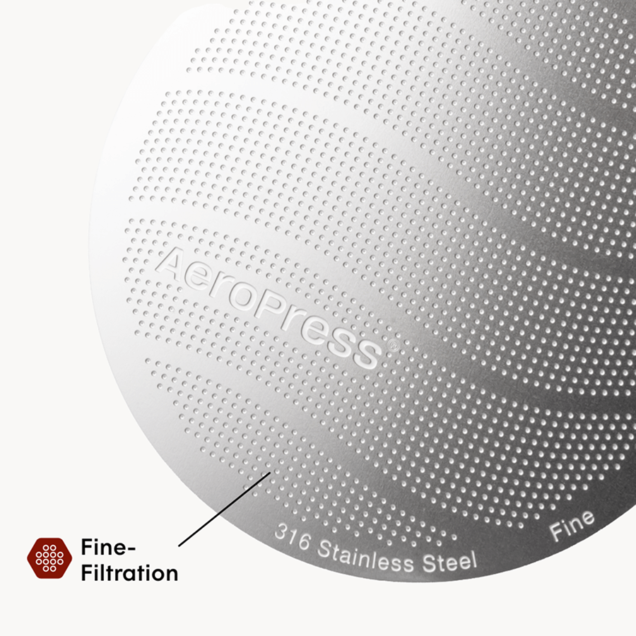 Close-up of an AeroPress coffee maker with 'AeroPress' branding and text indicating 316 stainless steel and fine filtration. #color_blue