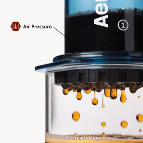 Close-up of a coffee brewing device with coffee dripping, labeled 'Air Pressure'.  #color_blue