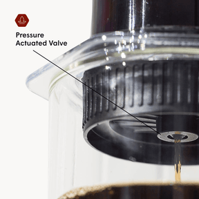 Close-up of a pressure actuated valve in a coffee brewing device with text label. #color_clear
