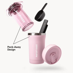 Pink AeroPress Go Plus coffee maker with components on a white background #color_pink