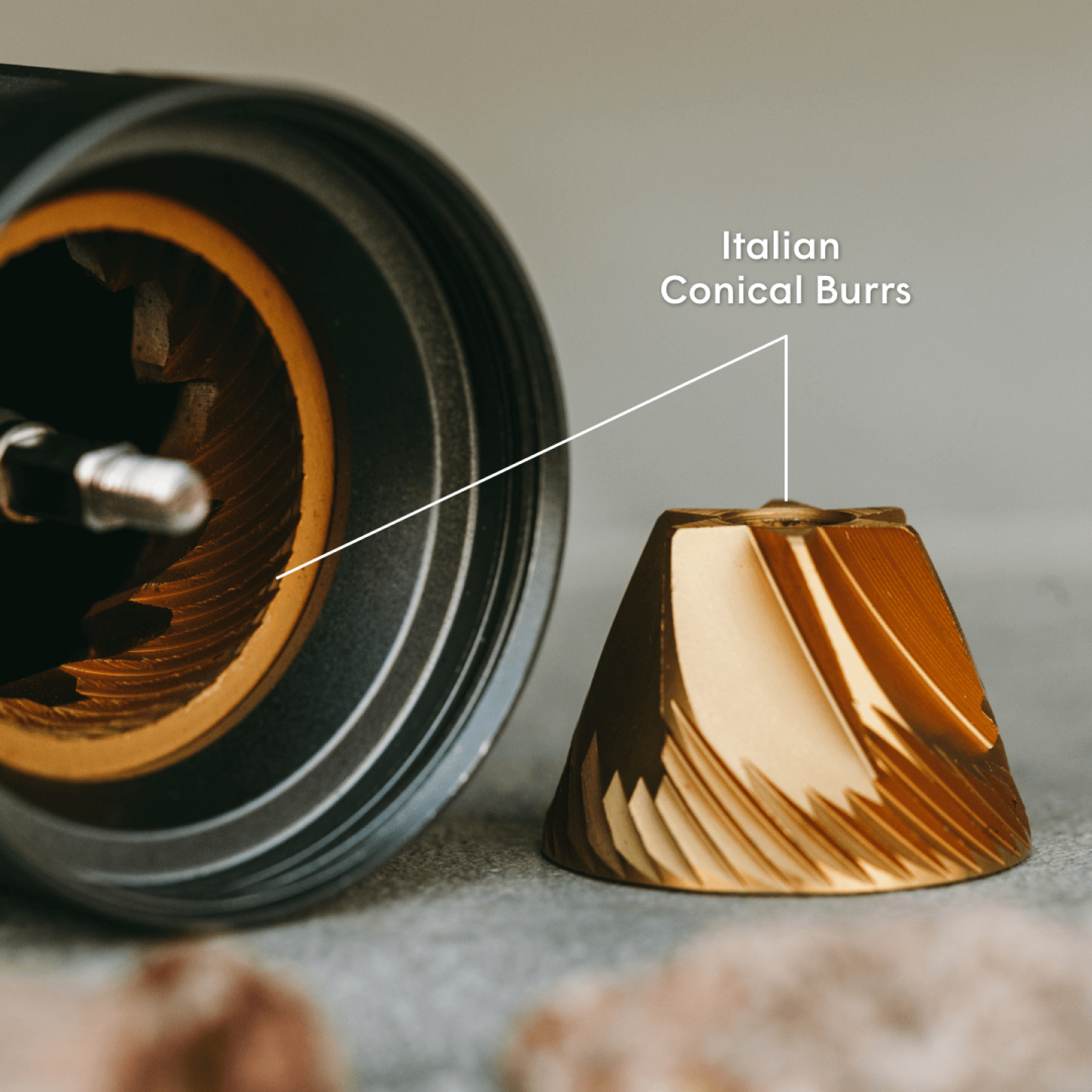 AeroPress Manual Coffee grinder with Italian conical burrs and a close-up of the burr on a neutral background.