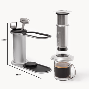 Aeropress coffee maker with a glass of coffee on a white background #color_silver