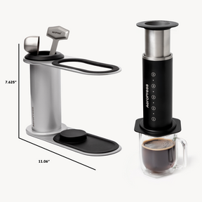 Aeropress coffee maker with a glass mug of coffee on a white background #color_black

