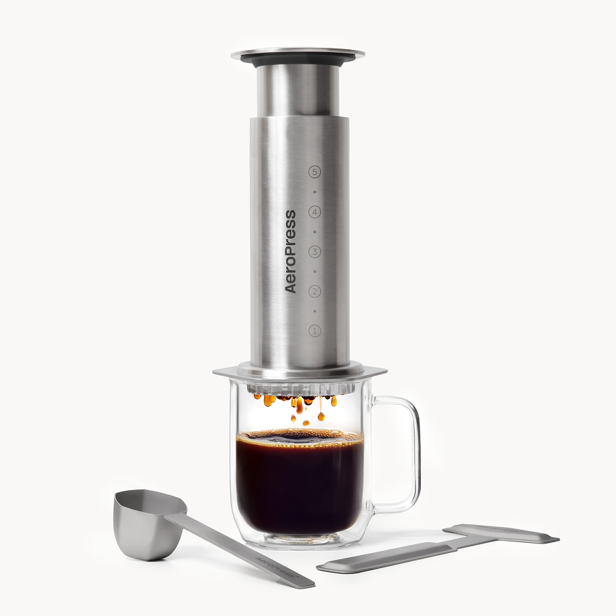 AeroPress Steel coffee maker with glass mug and scoop on a white background #color_silver