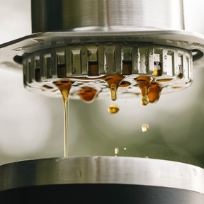 Close-up of AeroPress Steel with coffee dripping from the spout. #color_silver