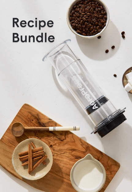 AeroPress recipe bundle with coffee beans, spices, and brewing setup on table